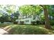 Charming single-story home with a well-manicured lawn, a white picket fence, and mature shade trees at 409 Green St, Sanford, NC 27330