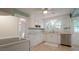 Well-lit kitchen with white appliances, white cabinetry, and tiled countertops at 409 Green St, Sanford, NC 27330