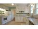Charming kitchen features white cabinetry, stainless sink, and ample counter space at 409 Green St, Sanford, NC 27330