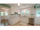 Updated kitchen with white cabinets, stainless steel dishwasher, and ample natural light at 409 Green St, Sanford, NC 27330