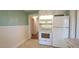 Well-lit kitchen featuring white appliances and cabinets, alongside a modern electric stove at 409 Green St, Sanford, NC 27330