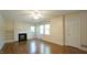 Bright living room featuring hardwood floors, fireplace, and abundant natural light at 409 Green St, Sanford, NC 27330