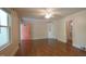 Hardwood living area featuring pink door and built-in shelving and cabinet at 409 Green St, Sanford, NC 27330