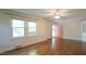 Open living space with hardwood floors, bright windows, and a cheerful pink door at 409 Green St, Sanford, NC 27330