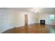 Spacious living area with hardwood floors, built-in shelving, and a cozy fireplace at 409 Green St, Sanford, NC 27330