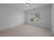 Inviting bedroom filled with natural light from a large window, offering a cozy and welcoming atmosphere with neutral carpet at 411 Westhampton Dr, Burlington, NC 27215