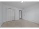 This bedroom includes neutral carpet, a closet, and an interior door that leads to another room at 411 Westhampton Dr, Burlington, NC 27215