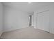 This bedroom features neutral carpet, double closet and access to a bathroom, offering comfort and practicality at 411 Westhampton Dr, Burlington, NC 27215
