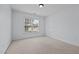 Comfortable bedroom featuring neutral carpet flooring, light-colored walls, and a window at 411 Westhampton Dr, Burlington, NC 27215