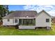 Rear view of the home showcasing the sunroom and well-kept backyard at 411 Westhampton Dr, Burlington, NC 27215