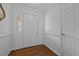 Bright foyer featuring a white paneled front door and classic wood flooring at 411 Westhampton Dr, Burlington, NC 27215
