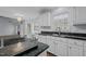 Bright kitchen featuring granite counters, stainless steel appliances, and large windows for ample natural light at 411 Westhampton Dr, Burlington, NC 27215