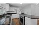 Well-lit kitchen featuring dark countertops, white cabinetry, and stainless steel appliances for a modern look at 411 Westhampton Dr, Burlington, NC 27215