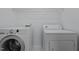 Functional laundry room equipped with a washer, dryer, and overhead storage, making laundry chores a breeze at 411 Westhampton Dr, Burlington, NC 27215