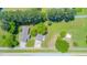 Aerial shot of a home with large yard and driveway, surrounded by trees and greenery at 4418 Carpenter Pond Rd, Durham, NC 27703