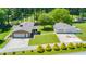 Aerial view of home with detached garage, spacious lawn, and well-manicured landscaping at 4418 Carpenter Pond Rd, Durham, NC 27703