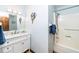 Bathroom with a white vanity, marble countertop, mirror and tub with shower at 4418 Carpenter Pond Rd, Durham, NC 27703