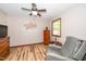 Cozy bedroom featuring a chair, wood dresser, ceiling fan, and a window for natural light at 4418 Carpenter Pond Rd, Durham, NC 27703