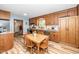 A dining table with wood chairs sits next to stainless steel appliances and wood cabinets at 4418 Carpenter Pond Rd, Durham, NC 27703