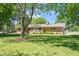 Charming brick house with a cozy front porch and a lush green lawn at 4418 Carpenter Pond Rd, Durham, NC 27703
