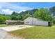 A well-maintained garage featuring two roll-up doors, offering generous space and functionality on a lush green lawn at 4418 Carpenter Pond Rd, Durham, NC 27703