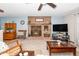 Spacious living room features brick fireplace, ceiling fan, and cozy furniture at 4418 Carpenter Pond Rd, Durham, NC 27703