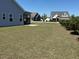 Large backyard and neighboring homes featuring manicured lawns and landscaping at 47 Scarlet Bell Dr, Youngsville, NC 27596