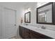 Modern bathroom featuring double vanity with marble countertops and dark wood cabinets at 47 Scarlet Bell Dr, Youngsville, NC 27596