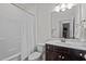 Standard bathroom with dark cabinets, a shower/tub combo, and a single vanity at 47 Scarlet Bell Dr, Youngsville, NC 27596