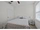 Cozy bedroom with a bed and bedside table; window provides natural light at 47 Scarlet Bell Dr, Youngsville, NC 27596