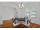 Dining room with hardwood floors, chandelier, and modern black and white chairs at 47 Scarlet Bell Dr, Youngsville, NC 27596