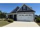 Charming two-story home with a manicured lawn, attached garage, and craftsman details at 47 Scarlet Bell Dr, Youngsville, NC 27596