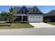 Charming two-story home with a manicured lawn, attached garage, and craftsman details at 47 Scarlet Bell Dr, Youngsville, NC 27596