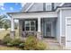 Inviting covered porch with stone pillars and seating area, perfect for relaxing outdoors at 47 Scarlet Bell Dr, Youngsville, NC 27596