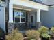 Inviting covered porch with stone pillars and seating area, perfect for relaxing outdoors at 47 Scarlet Bell Dr, Youngsville, NC 27596