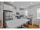 A gourmet kitchen featuring white cabinets, stainless steel appliances, and a functional center island at 47 Scarlet Bell Dr, Youngsville, NC 27596