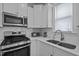 Modern kitchen featuring stainless steel appliances, white subway tile backsplash, and quartz countertops at 47 Scarlet Bell Dr, Youngsville, NC 27596