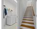 Clean laundry room with modern washer and dryer. Staircase leads to the upper level at 47 Scarlet Bell Dr, Youngsville, NC 27596