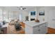 Bright and airy living room and kitchen featuring a hardwood floor, white cabinets, and white walls at 47 Scarlet Bell Dr, Youngsville, NC 27596