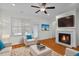 Cozy living room with fireplace, hardwood floors, and neutral-toned furnishings at 47 Scarlet Bell Dr, Youngsville, NC 27596