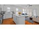 Bright and airy living room and kitchen featuring a hardwood floor, white cabinets, and white walls at 47 Scarlet Bell Dr, Youngsville, NC 27596