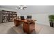 Spacious home office features hardwood floors, a large desk, and built-in bookshelves at 47 Scarlet Bell Dr, Youngsville, NC 27596