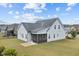 Back of the house with a screened porch and well-maintained lawn, perfect for outdoor relaxation at 47 Scarlet Bell Dr, Youngsville, NC 27596