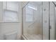 Clean shower features glass surround with tile and shower head. Window provides natural light at 47 Scarlet Bell Dr, Youngsville, NC 27596