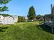 Beautiful backyard featuring green grass, shed, white picket fence, and partial deck view at 4908 Birkenhead Ct, Apex, NC 27539