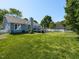 Lush backyard with a view of the deck and the back of the house at 4908 Birkenhead Ct, Apex, NC 27539