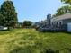 Large backyard features a spacious lawn and a deck accessible via steps at 4908 Birkenhead Ct, Apex, NC 27539