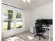 Carpeted bedroom featuring a large window and desk setup with office chair at 4908 Birkenhead Ct, Apex, NC 27539