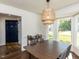 Stylish dining area with bay window, modern light fixture, and easy access to front door at 4908 Birkenhead Ct, Apex, NC 27539