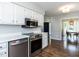 The stainless steel appliances nicely complement the white cabinets in the kitchen at 4908 Birkenhead Ct, Apex, NC 27539